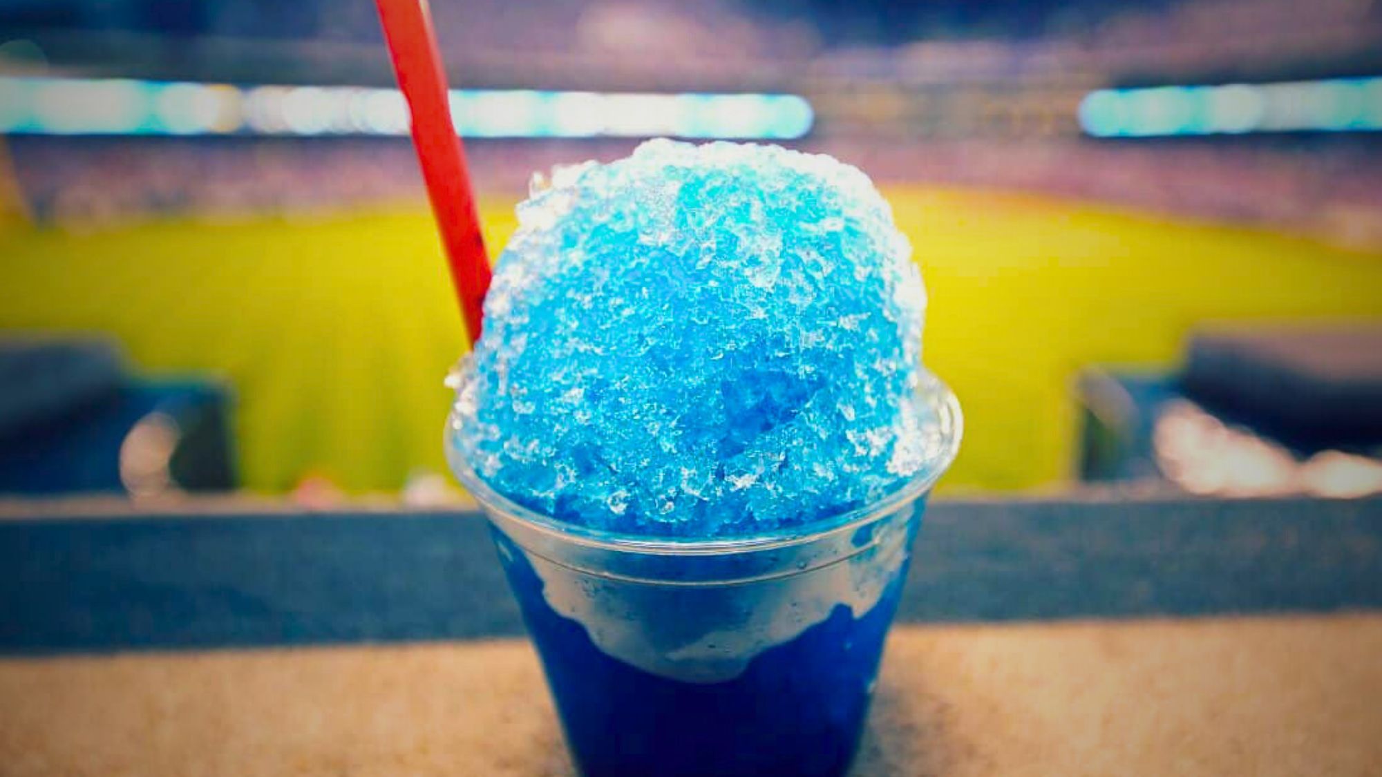 A refreshing blue ice cream drink, tangy tango ice blast, served in a cup at a baseball stadium